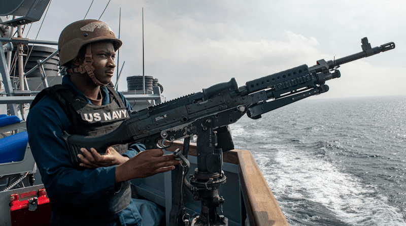 Navy Seaman Jeremiah Bridges mans a M-240 machine gun on the USS Paul Hamilton while transiting the Strait of Hormuz. Photo Credit: Navy Petty Officer 2nd Class Elliot Schaudt