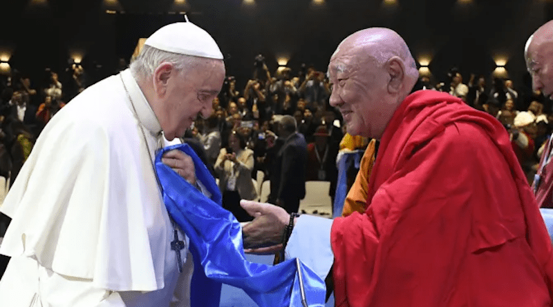 Khamba Nomun Khan, the head of the Gandan Monastery in Ulaanbaatar, accompanied Pope Francis as he made his entrance at the interreligious dialogue event at the Hun Theater in Mongolia on Sept. 3, 2023. | Vatican Media