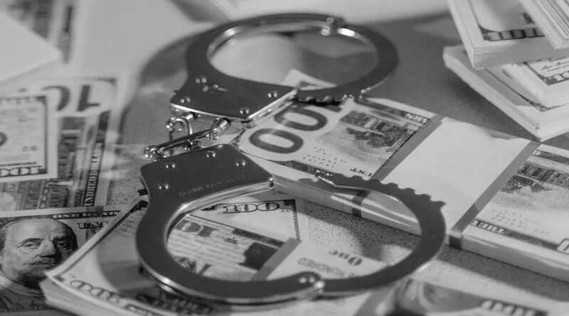 money dollars currency handcuffs crime
