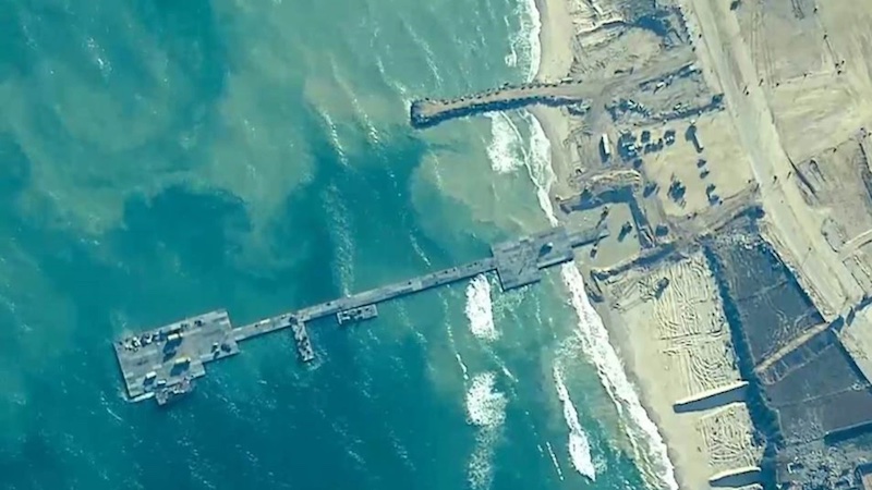 U.S. Army Soldiers with the 7th Transportation Brigade (Expeditionary), U.S. Navy Sailors assigned to Amphibious Construction Battalion 1, and Israel Defense Forces emplace the Trident Pier on the Gaza coast, May 16, 2024. Photo Credit: DOD