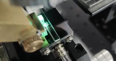 The photo shows light being focused through the microlens array onto the micro-ring in the OPCA chip test system. CREDIT: Wei Wu, Tsinghua University