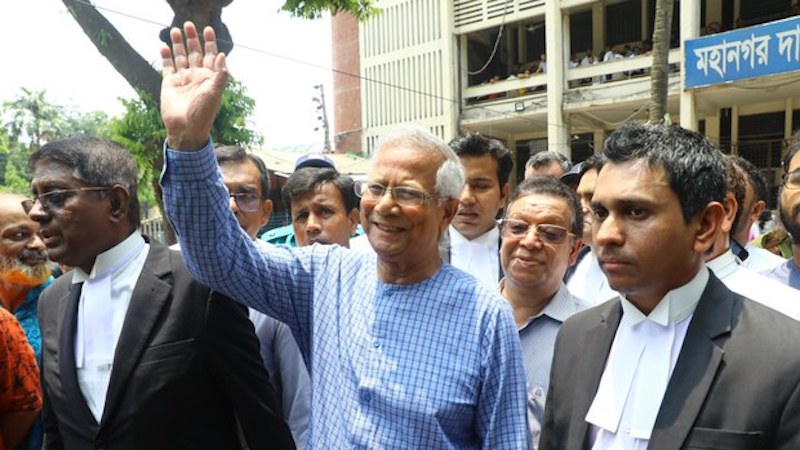 Nobel Laureate Muhammad Yunus waves to reporters as he leaves the Special Judge’s Court in Dhaka, June 12, 2024. Photo Credit: Mehedi Rana/BenarNews