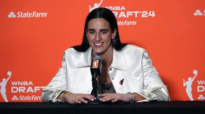 Caitlin Clark addresses the media in her press conference shortly after being selected first overall in the 2024 WNBA Draft. Photo Credit: JazzyJoeyD, Wikipedia Commons
