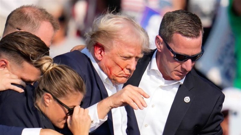 Members of Secret Service rush former US President Donald Trump off stage after assassination attempt. Photo Credit: Tasnim News Agency
