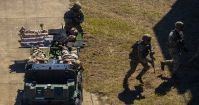 Soldiers of the Maneuver Center of Excellence Experimental Company, 1st Battalion, 29 Infantry Regiment, 316th Cavalry Brigade, employ integrated robotics during a simulated operation as attendees of the Human Machine Integration Summit II view. (U.S. Army photo by Denise Mosley)